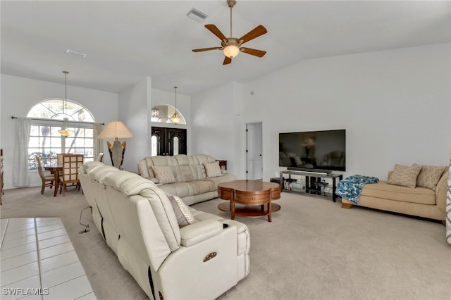 living room with high vaulted ceiling, light colored carpet, and ceiling fan