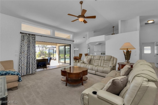 carpeted living room featuring ceiling fan and high vaulted ceiling