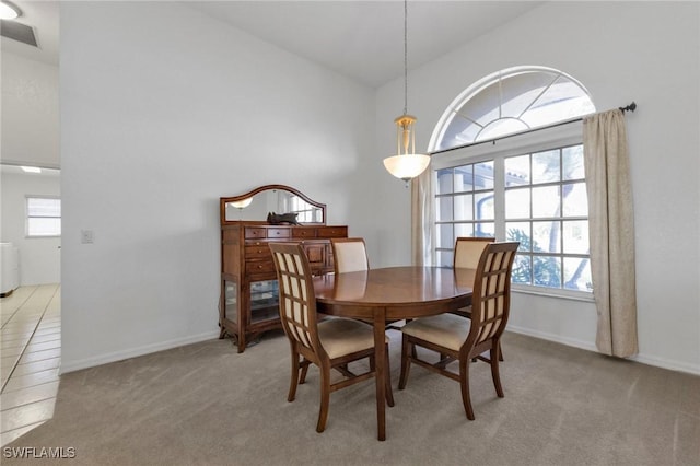 25373 Tether Ln, Punta Gorda, FL 33983 - dining room with lofted ceiling, light carpet, and baseboards