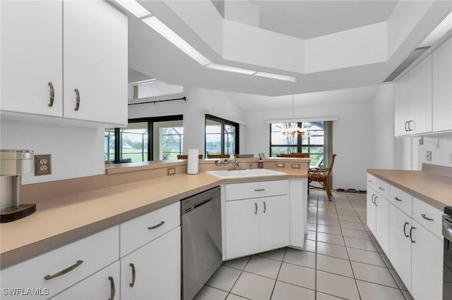 25373 Tether Ln, Punta Gorda, FL 33983 - kitchen featuring stainless steel dishwasher, a sink, light countertops, light tile patterned flooring, and a raised ceiling