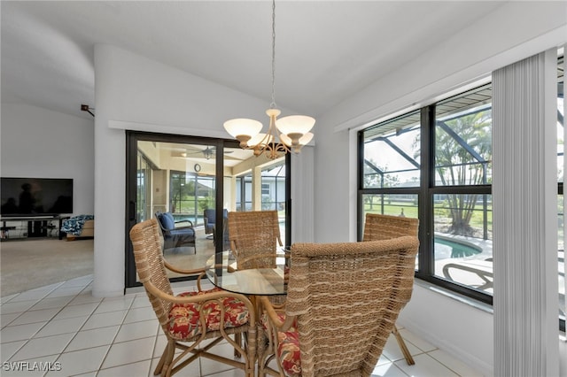 dining space with light colored carpet, a notable chandelier, and lofted ceiling