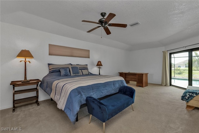 bedroom with access to outside, a textured ceiling, light carpet, and ceiling fan