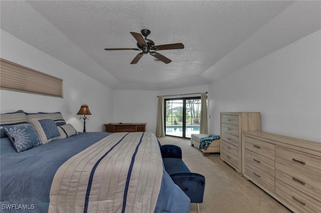 bedroom featuring a textured ceiling, access to outside, light colored carpet, and ceiling fan