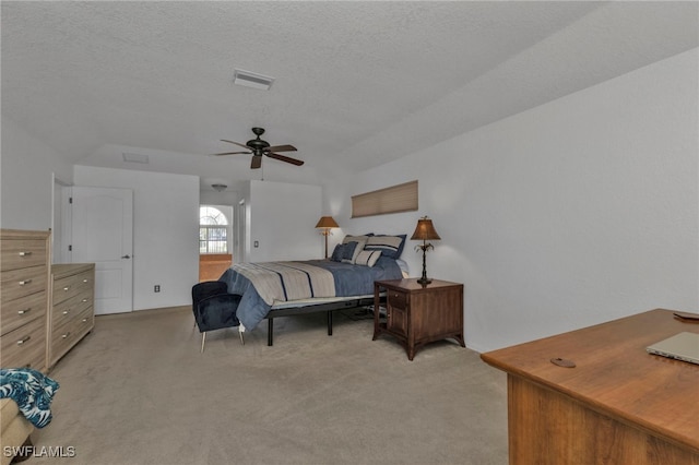 carpeted bedroom with a textured ceiling and ceiling fan