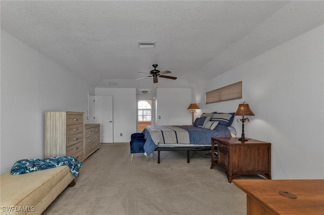 bedroom featuring a textured ceiling, light carpet, and ceiling fan