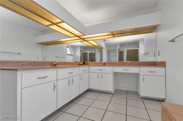 25373 Tether Ln, Punta Gorda, FL 33983 - kitchen with white cabinets and light tile patterned floors