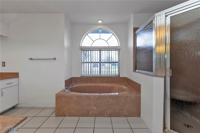 bathroom with tile patterned flooring, vanity, and separate shower and tub