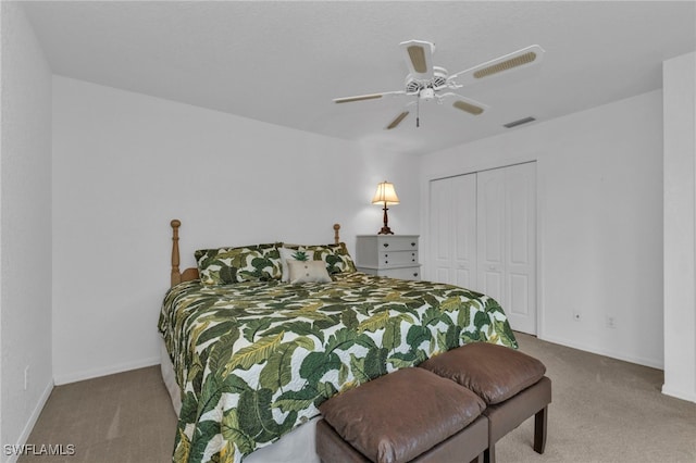 carpeted bedroom featuring a closet and ceiling fan