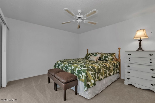 carpeted bedroom featuring a closet and ceiling fan