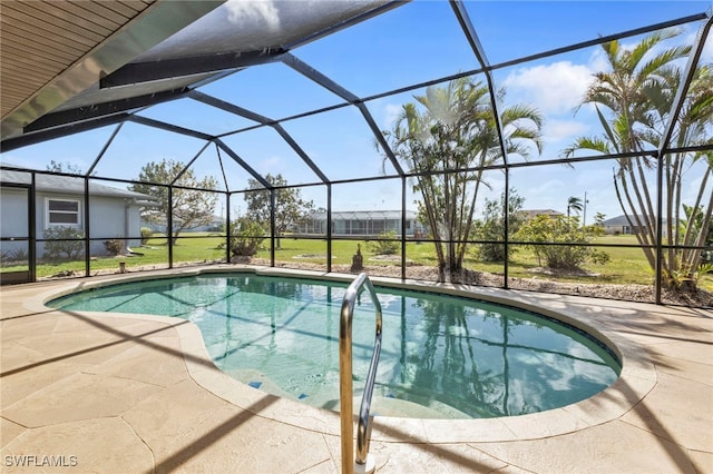 view of pool with a lanai, a patio, and a yard