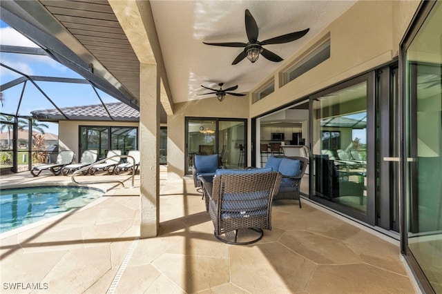 view of swimming pool with glass enclosure, a patio, and ceiling fan