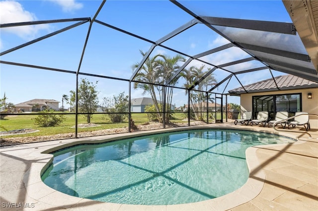 view of swimming pool featuring a lanai and a patio area