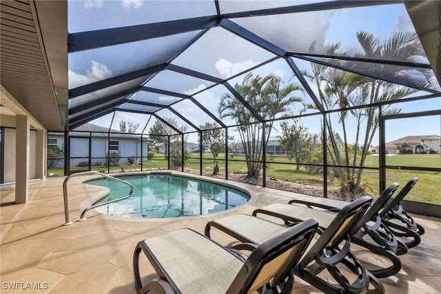 view of pool featuring a patio, a lawn, and glass enclosure