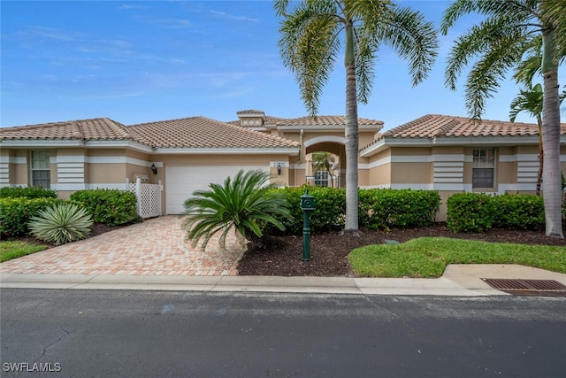 mediterranean / spanish-style home featuring a garage