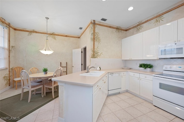 kitchen featuring kitchen peninsula, white appliances, hanging light fixtures, white cabinets, and sink