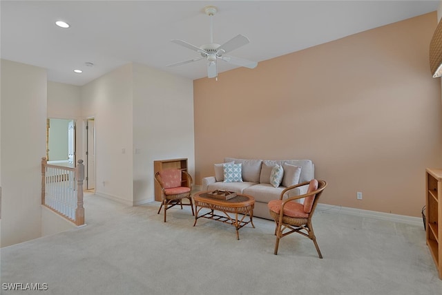 sitting room with ceiling fan and light colored carpet