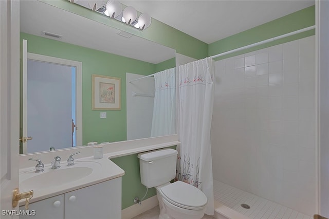 bathroom with toilet, vanity, and a shower with shower curtain