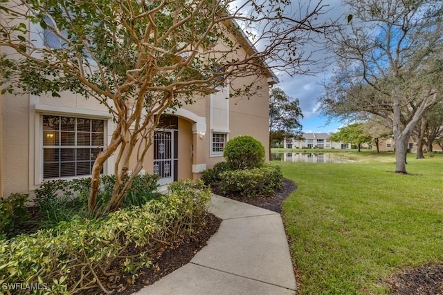 entrance to property featuring a yard