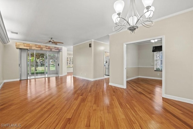 unfurnished living room featuring a healthy amount of sunlight, visible vents, and ornamental molding