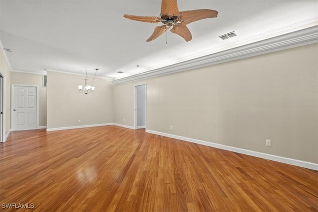 spare room featuring ornamental molding, ceiling fan with notable chandelier, and light wood-type flooring