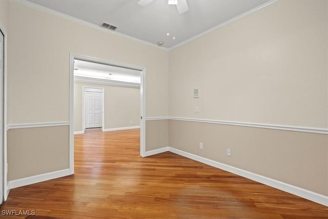 unfurnished room featuring crown molding, hardwood / wood-style floors, and ceiling fan