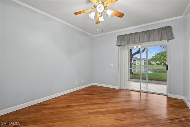 unfurnished room featuring crown molding, a water view, ceiling fan, and hardwood / wood-style flooring