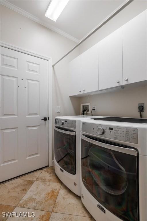 washroom featuring cabinet space, separate washer and dryer, and crown molding