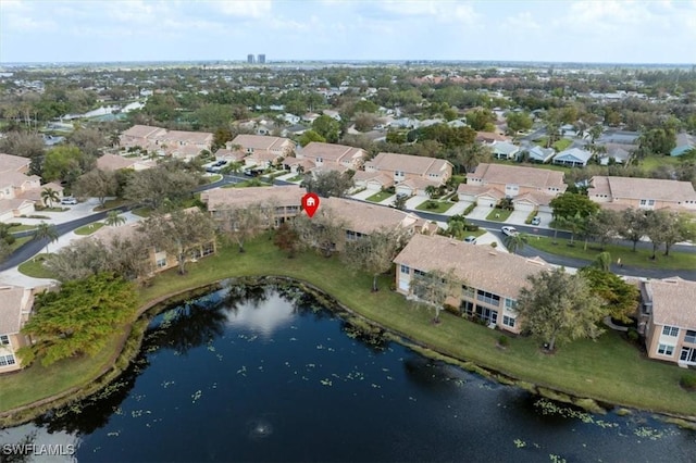 drone / aerial view with a residential view and a water view