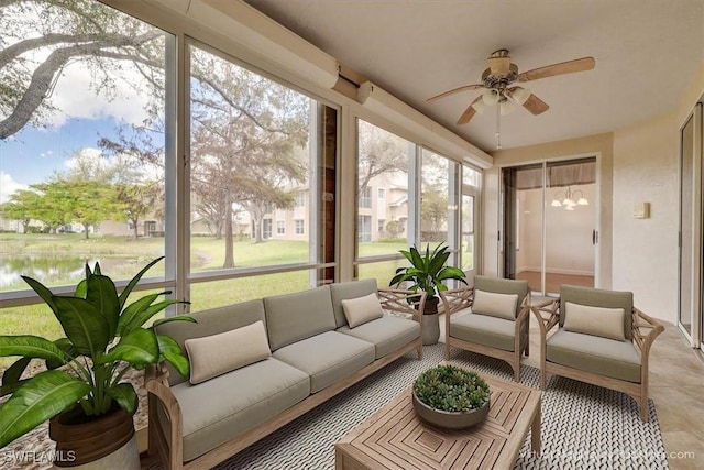 sunroom / solarium featuring a water view and ceiling fan