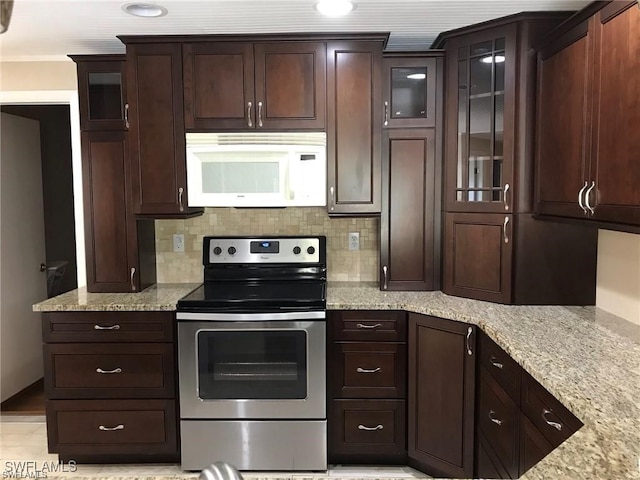 kitchen featuring light stone countertops, stainless steel electric range, dark brown cabinets, and decorative backsplash