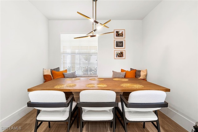 dining space with wood-type flooring