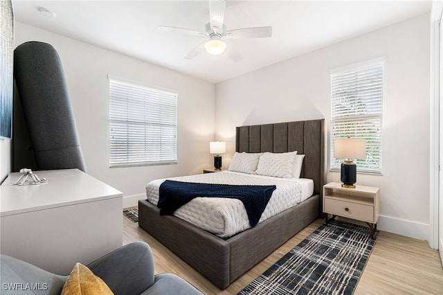 bedroom with ceiling fan and light hardwood / wood-style floors