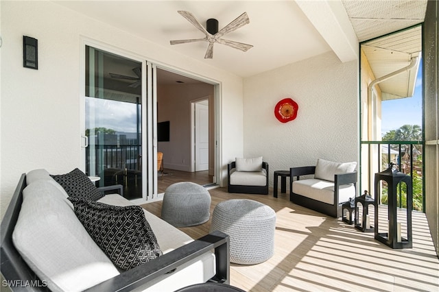 view of patio with ceiling fan and a balcony