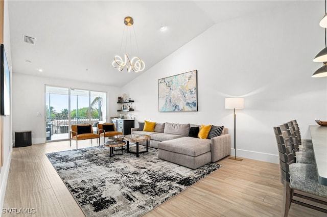 living room featuring lofted ceiling and light hardwood / wood-style floors