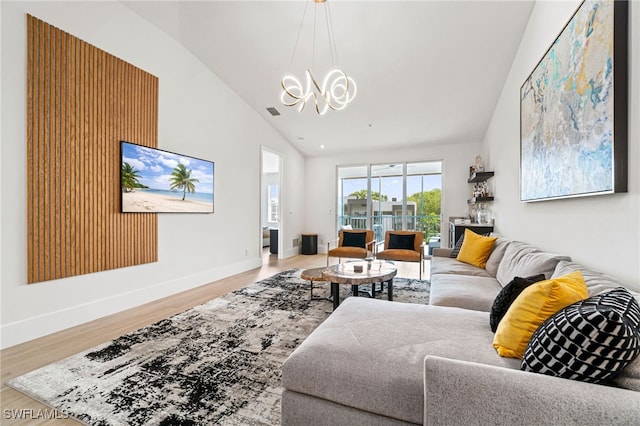 living room with vaulted ceiling and light hardwood / wood-style flooring