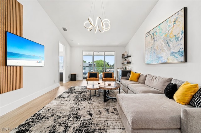 living room featuring light wood-type flooring and vaulted ceiling