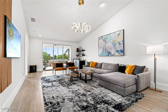 living room featuring high vaulted ceiling and light hardwood / wood-style floors