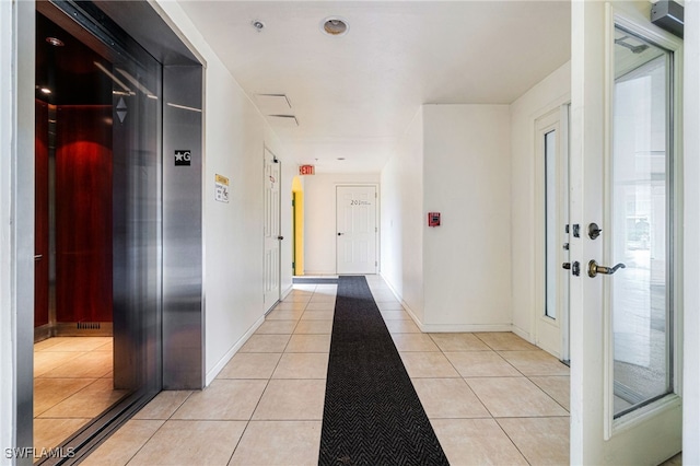 corridor with light tile patterned floors