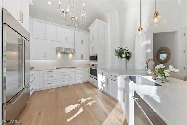 kitchen featuring pendant lighting, white cabinetry, sink, and appliances with stainless steel finishes