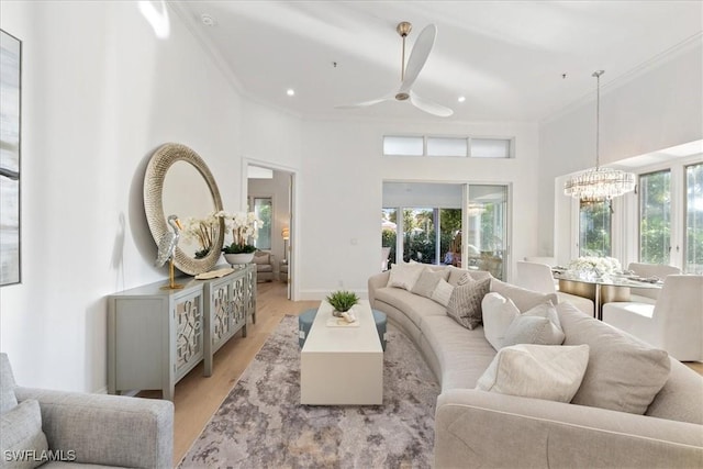 living room featuring a wealth of natural light, light hardwood / wood-style flooring, and ornamental molding