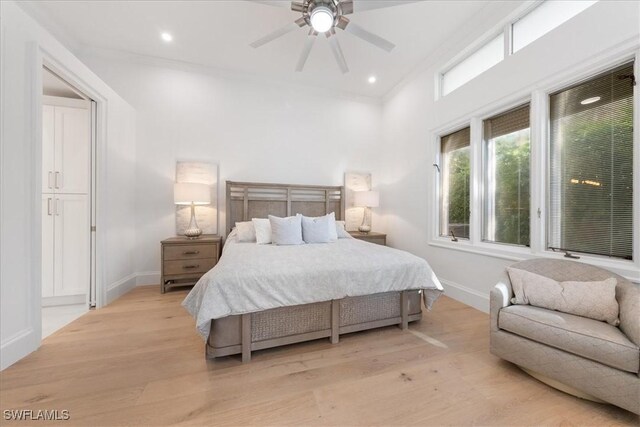 bedroom with ceiling fan, light hardwood / wood-style flooring, and ornamental molding