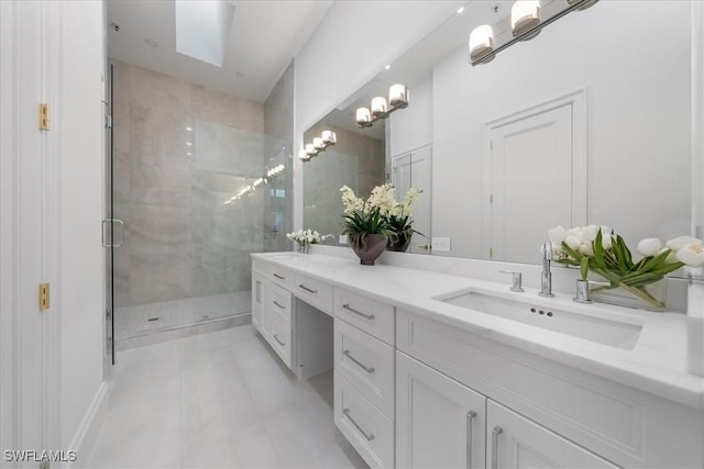 bathroom featuring tile patterned floors, vanity, an enclosed shower, and a skylight