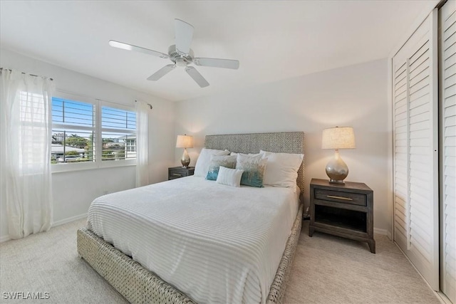 bedroom with ceiling fan and light carpet