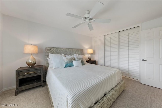 bedroom with ceiling fan and light colored carpet