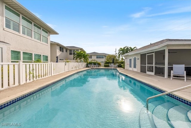 view of pool with a patio area and a sunroom