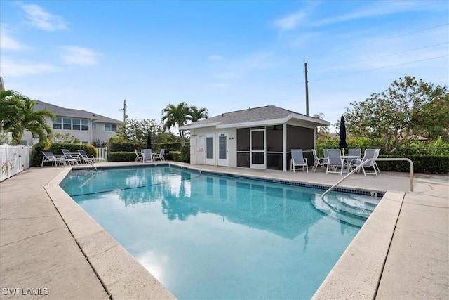 view of pool featuring a sunroom and a patio