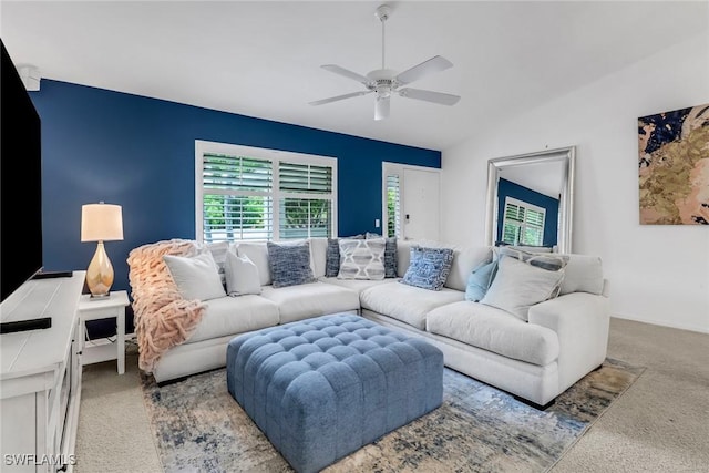 living room with ceiling fan, vaulted ceiling, and carpet flooring