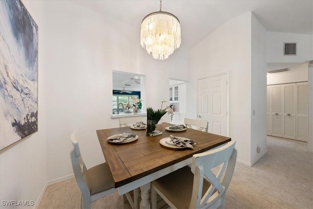 carpeted dining space with a notable chandelier