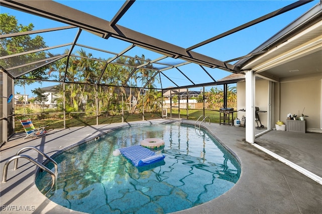 view of swimming pool with a patio area and a lanai