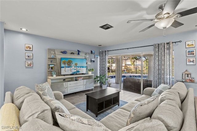 living room with ceiling fan and hardwood / wood-style flooring